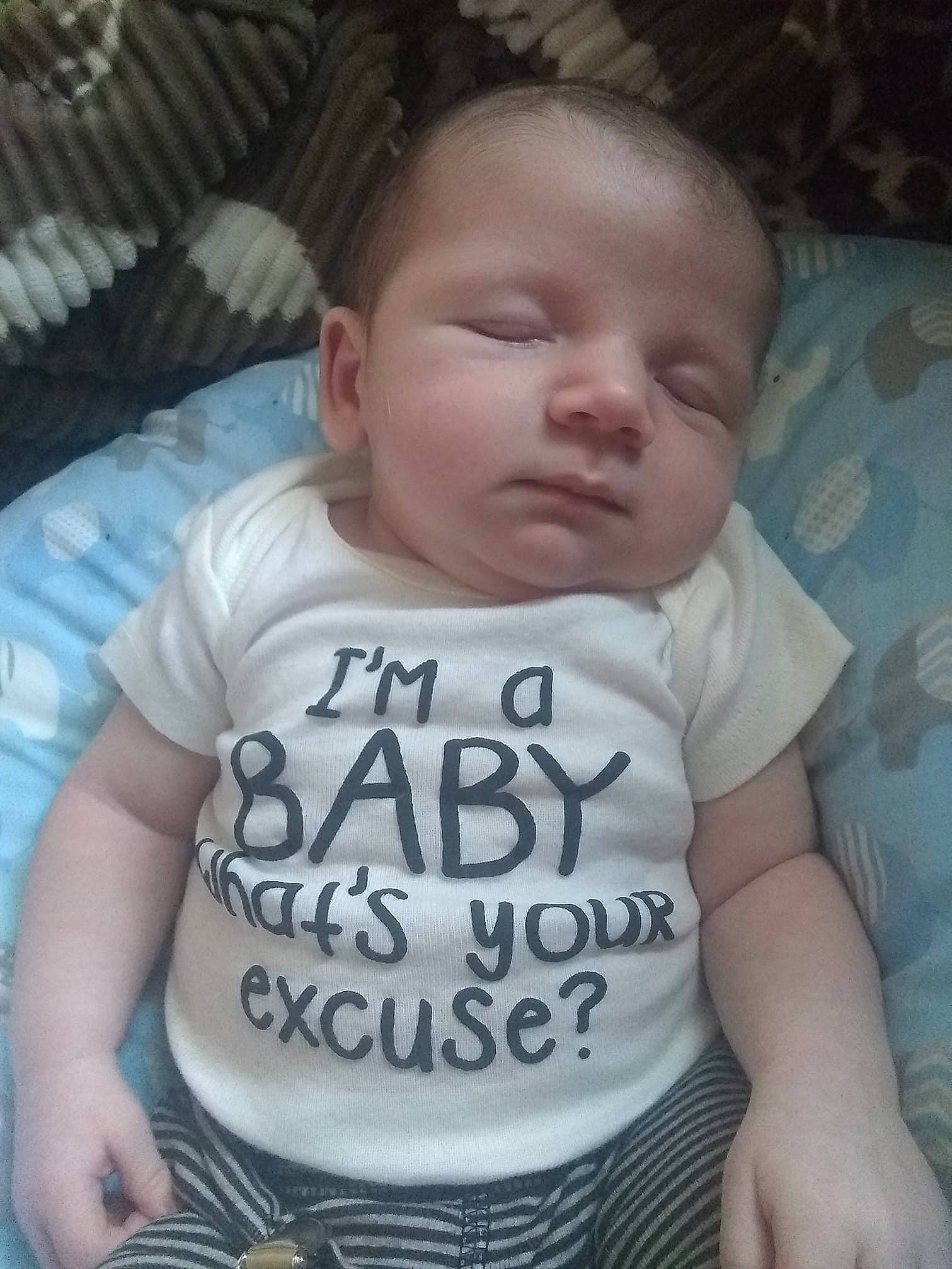 Colin Jr is registered to the contest to win money with this photo: baby, baby_products, baby_toddler_clothing, cheek, child, cool, face, forehead, head, nap, nose, person, product, skin, sleep, sleeve, smile, t_shirt, toddler