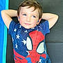 child, boy, blue_eyes, spiderman, tshirt, relaxed, laying_down, mat, casual, short_hair, cute, portrait, indoor, resting, childhood, superhero, colorful_clothing, happy, young, bright