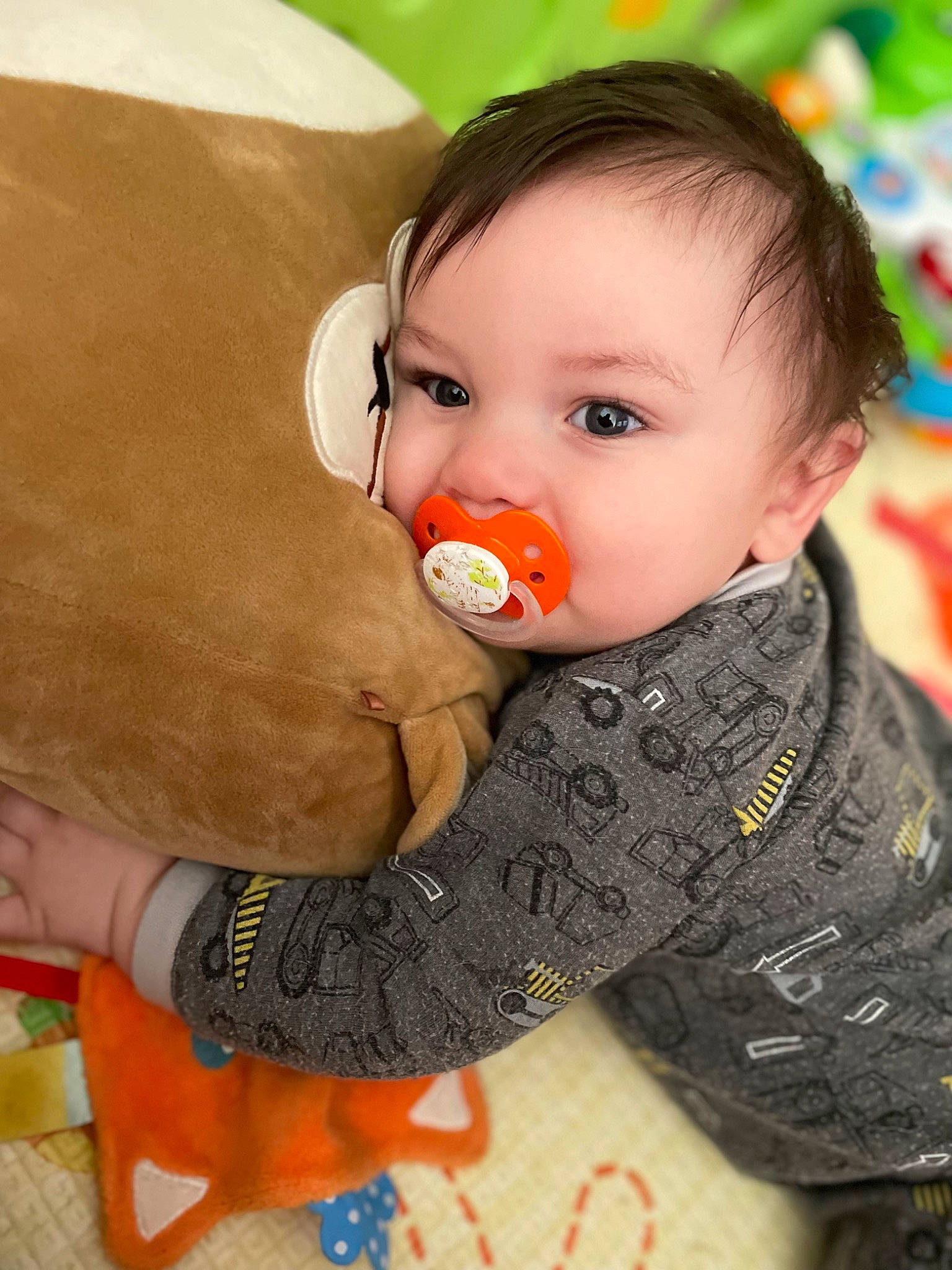 Julian is registered to the contest to win money with this photo: baby, baby_playing_with_toys, baby_toddler_clothing, baby_toys, cheek, child, comfort, eye, flooring, fun, happy, mammal, nose, orange, pattern, person, sitting, skin, sleeve, toddler