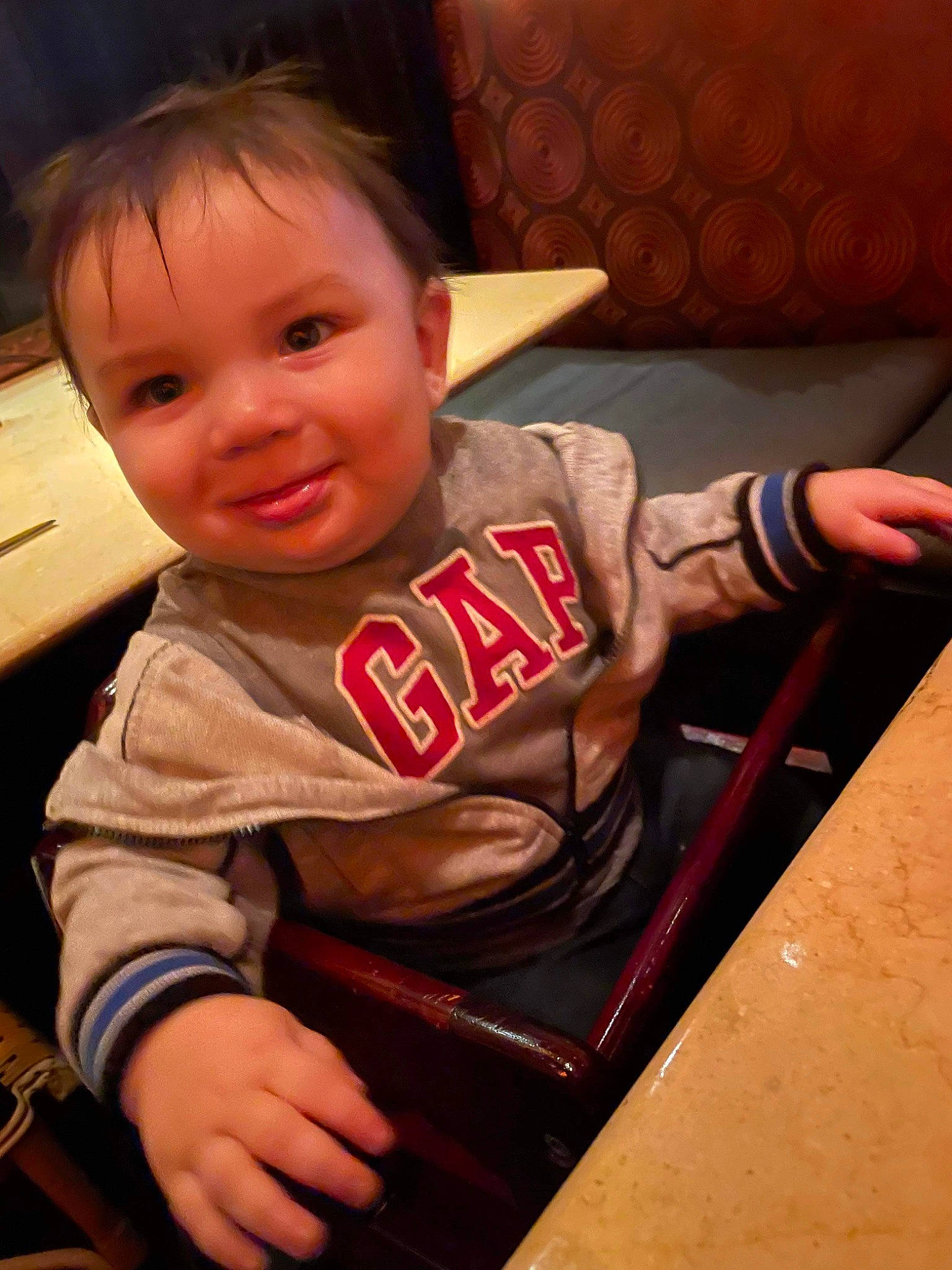 Julian is registered to the contest to win money with this photo: baby, baby_toddler_clothing, chair, cheek, chin, comfort, cool, finger, fun, happy, human_body, joy, lap, mouth, nose, person, skin, sleeve, smile, thumb