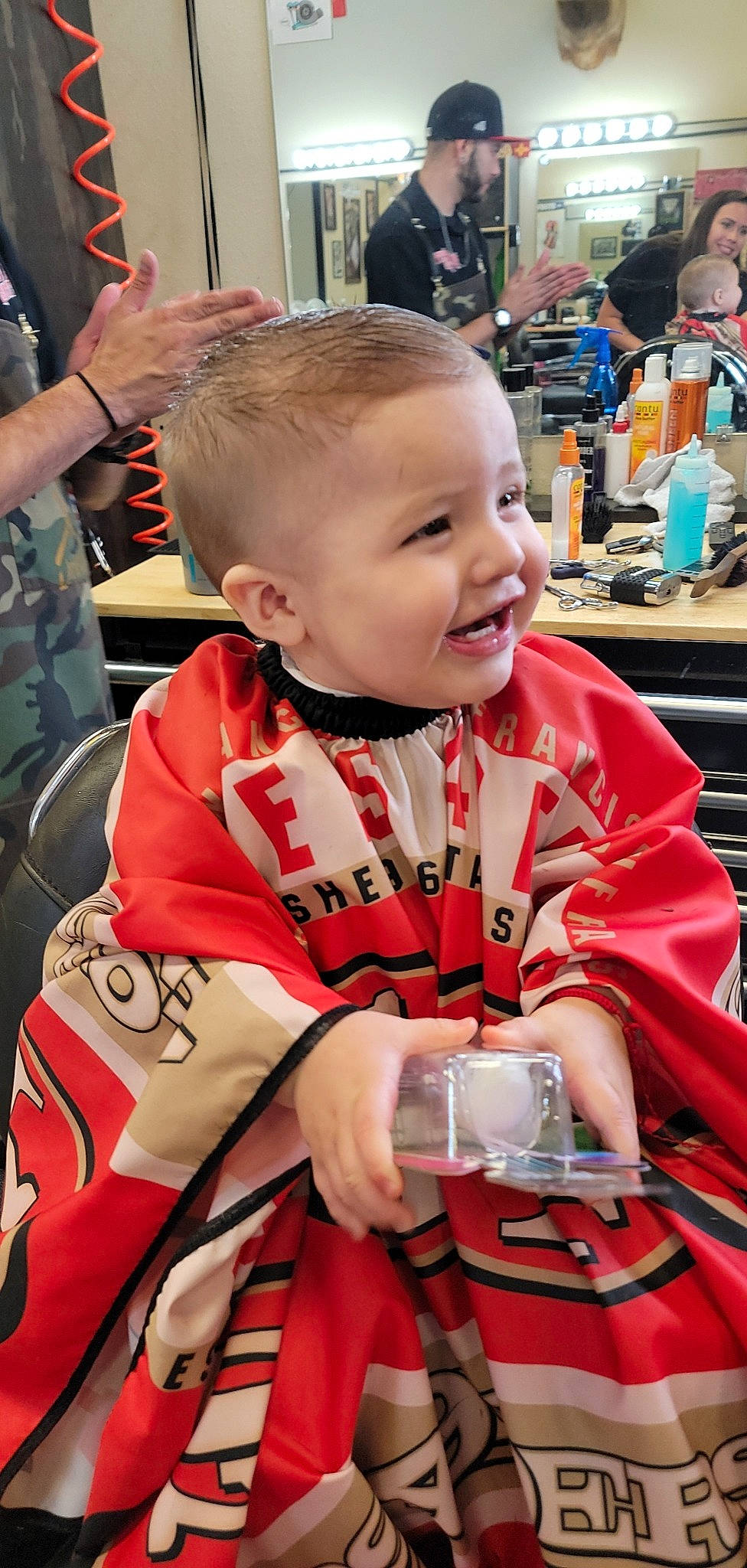 Ahlito joined the competition — help win amazing prizes! baby, child, costume, event, facial_expression, fun, happy, headwear, joy, person, personal_protective_equipment, recreation, sitting, smile, t_shirt, toddler, tradition, uniform, vacation