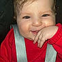 baby, child, smile, red_sweater, car_seat, harness, hand, face, cheeks, cute, infant, happy, person, clothing, seatbelt, closeup, indoor, portrait, skin, hair