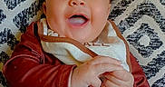 Styles joined the competition — help win amazing prizes! baby, infant, smiling, laughing, clothing, striped_pants, bib, cushion, patterned_cushion, happy, child, person, indoors, casual, cute, portrait, relaxed, joyful, infant_fashion, comfort