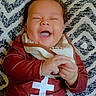baby, infant, smiling, laughing, clothing, striped_pants, bib, cushion, patterned_cushion, happy, child, person, indoors, casual, cute, portrait, relaxed, joyful, infant_fashion, comfort