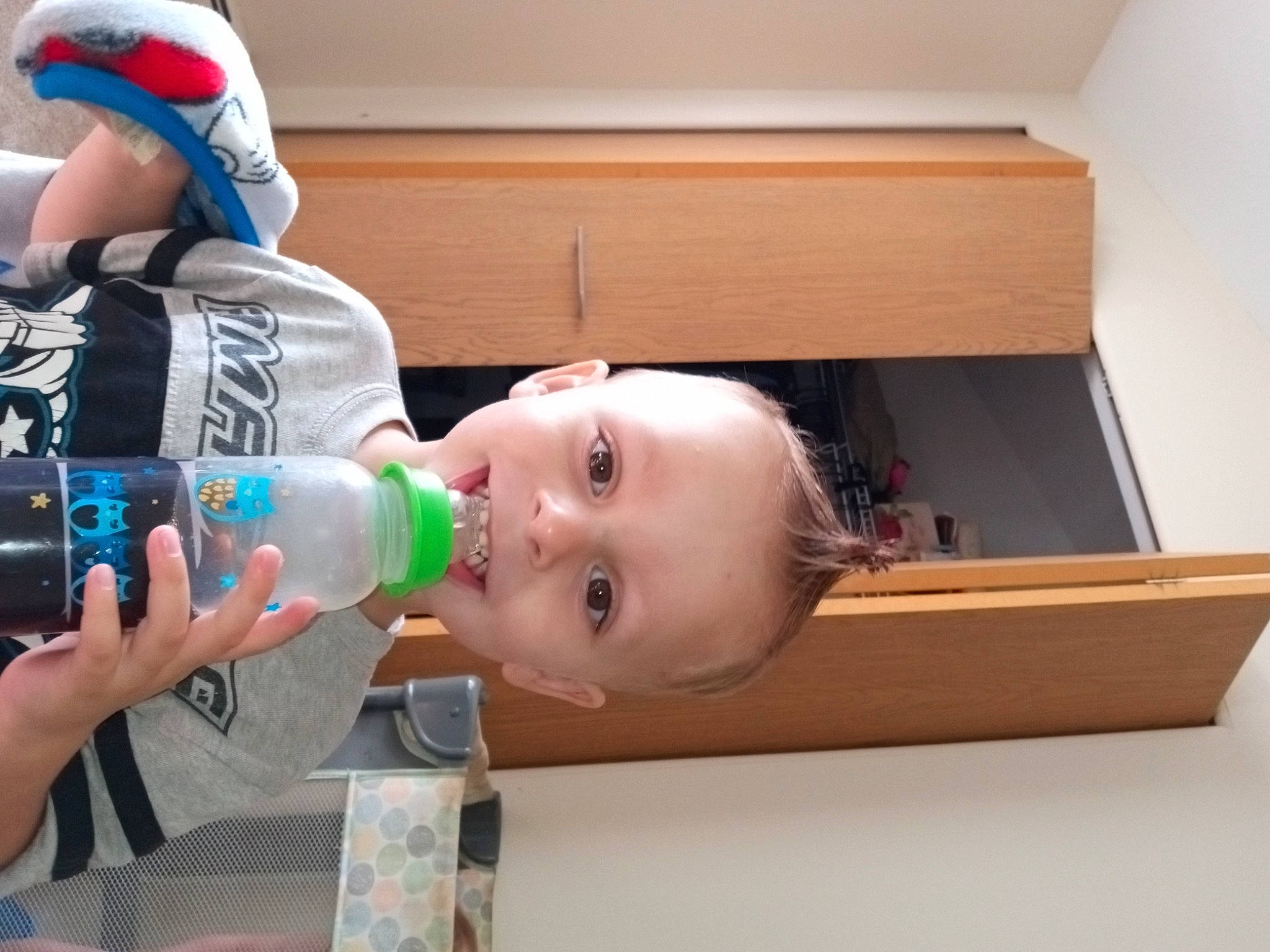 Elijah is registered to the contest to win money with this photo: baby, baby_bottle, baby_products, baby_toddler_clothing, bottle, child, drink, drinking, drinking_water, drinkware, happy, hardwood, joy, nail, person, plastic, plastic_bottle, room, toddler, water