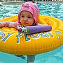 Maëlys a rejoint le concours — aidez-le/la à gagner de superbes lots ! toddler, child, pool, swimming, inflatable_ring, water_toy, pink_hat, yellow_ring, water, summer, outdoor, people, relaxing, swimwear, unicorn_toy, sunhat, floating, daytime, recreation, leisure