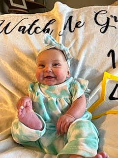 Nadia joined the competition — help win amazing prizes! baby, baby_products, baby_toddler_clothing, cheek, child, comfort, eye, font, fun, happy, joy, linens, person, photo_caption, product, room, sitting, sleeve, smile, textile