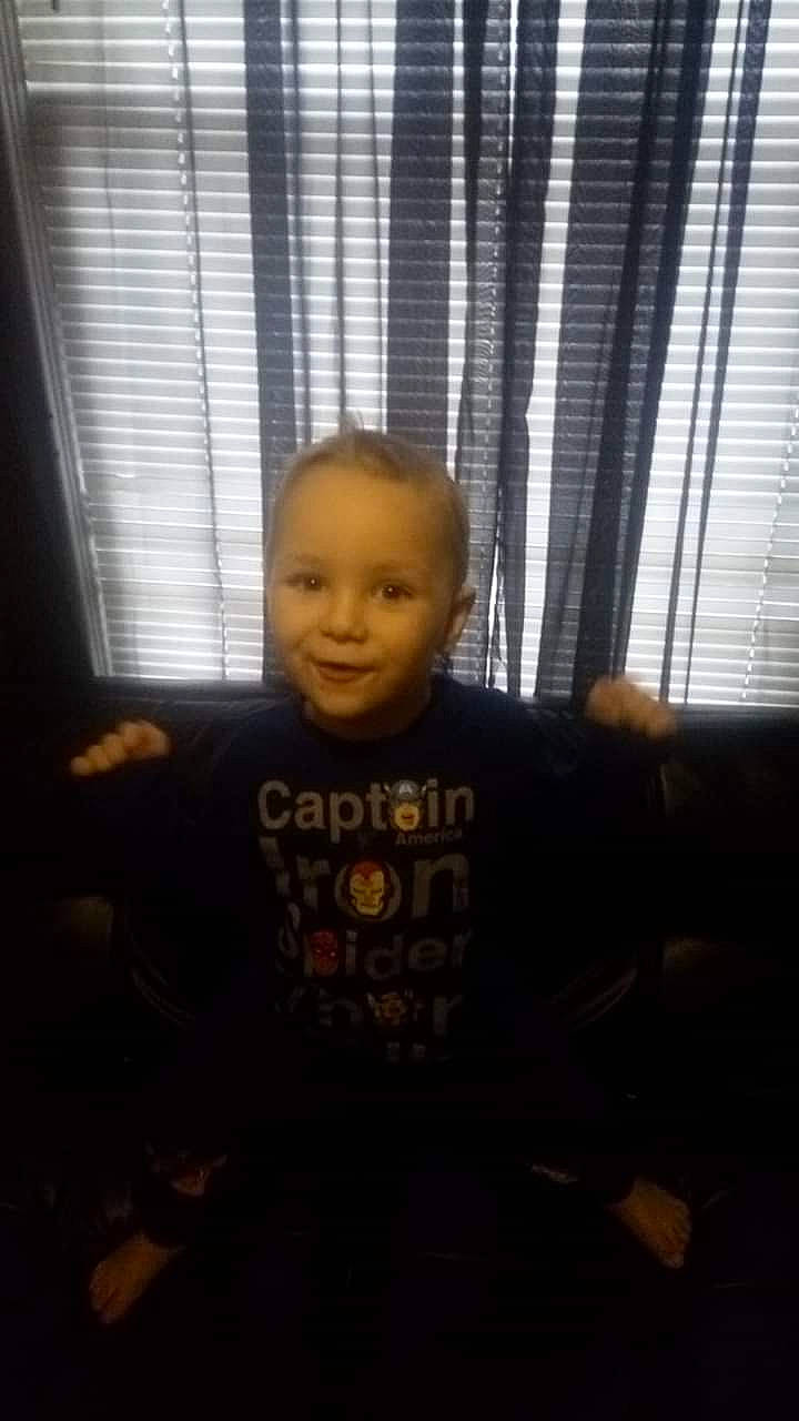 Wilfred is registered to the contest to win money with this photo: arm, cheek, child, chin, cool, eye, face, facial_expression, forehead, fun, head, male, mouth, nose, person, sitting, skin, smile, snapshot, standing