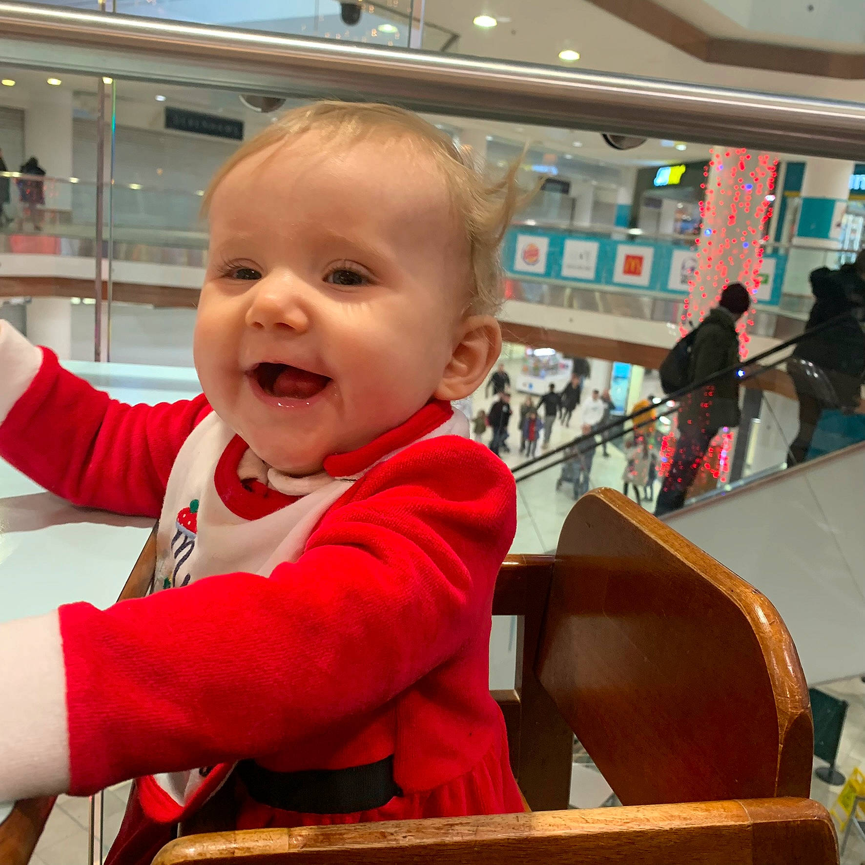 Maddie is registered to the contest to win money with this photo: arm, baby, baby_toddler_clothing, chair, cheek, child, customer, fun, hairstyle, happy, leisure, person, shopping, sitting, skin, sleeve, smile, standing, t_shirt, toddler