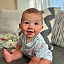 baby, child, clothing, couch, cozy, cute, expression, face, feet, hands, happy, home, indoors, infant, natural_light, person, pillow, portrait, sitting, smiling