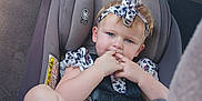 Lariah Ronda Dennis is registered to the contest to win money with this photo: toddler, child, car_seat, baby_bottle, headband, blue_eyes, sitting, car_interior, seatbelt, cute, girl, clothing, milk, fingers, young_child, infant, car, safety_harness, portrait, casual
