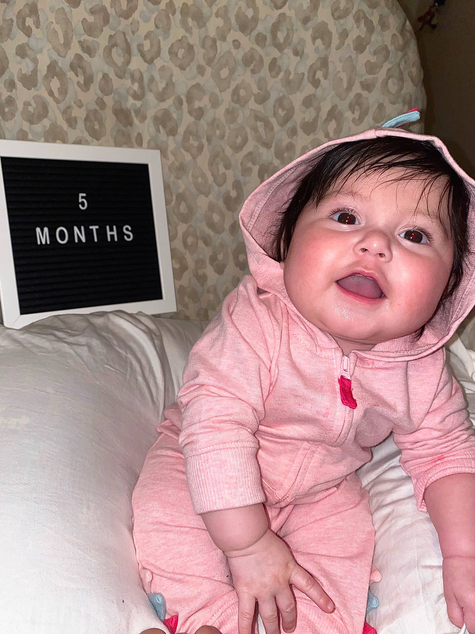 Katherine is registered to the contest to win money with this photo: baby, baby_products, baby_sleeping, baby_toddler_clothing, cheek, child, comfort, eyelash, fashion_accessory, gesture, happy, linens, magenta, nose, person, pink, room, sitting, skin, sleeve