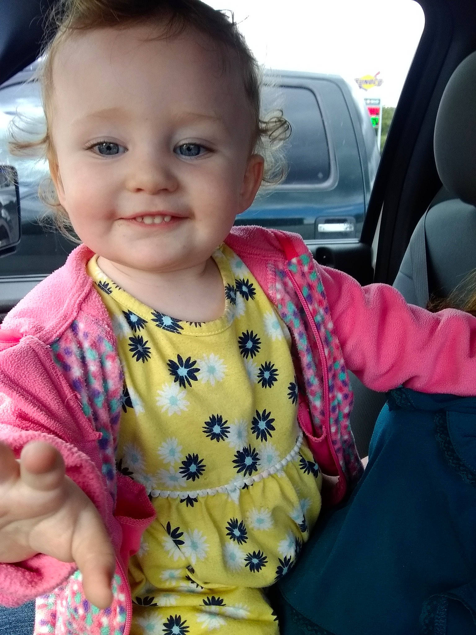 Isabella joined the competition — help win amazing prizes! baby, car, car_seat, cheek, child, joy, outerwear, person, skin, smile, toddler, vehicle
