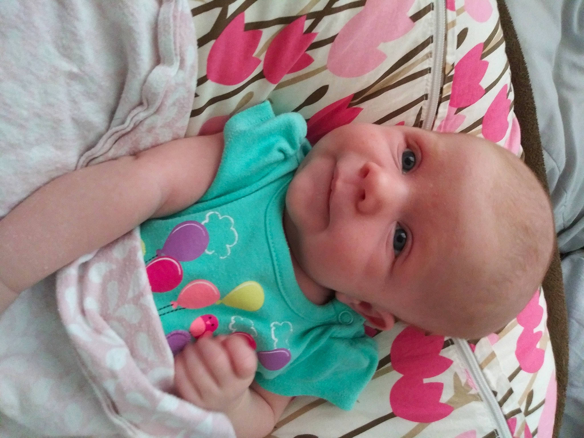 Natalie is registered to the contest to win money with this photo: baby, baby_products, baby_toddler_clothing, cheek, child, comfort, eye, finger, hand, head, human_body, iris, linens, lip, mouth, nose, person, pink, skin, textile