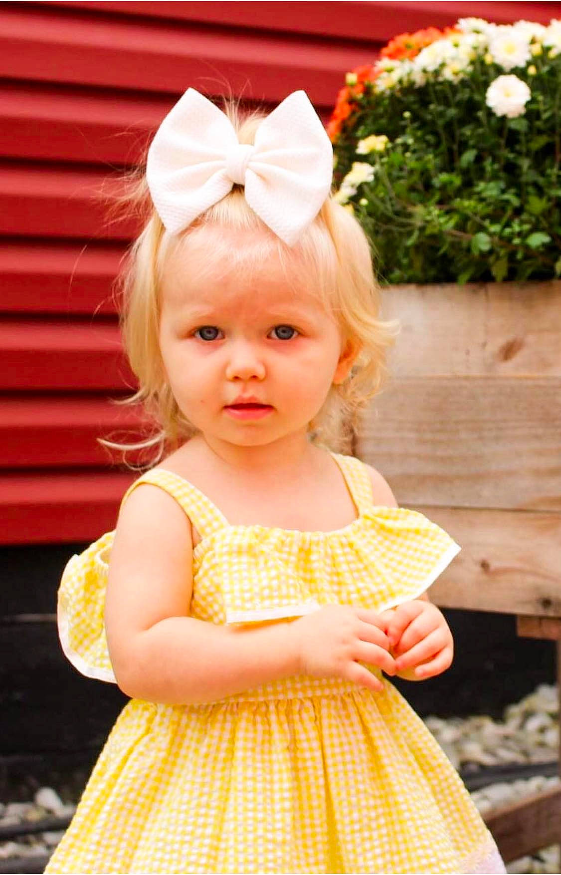 Adaline is registered to the contest to win money with this photo: baby, baby_toddler_clothing, child, child_model, clothing, design, dress, ear, fashion_accessory, hair_accessory, headband, headgear, pattern, peach, person, pink, polka_dot, toddler, yellow