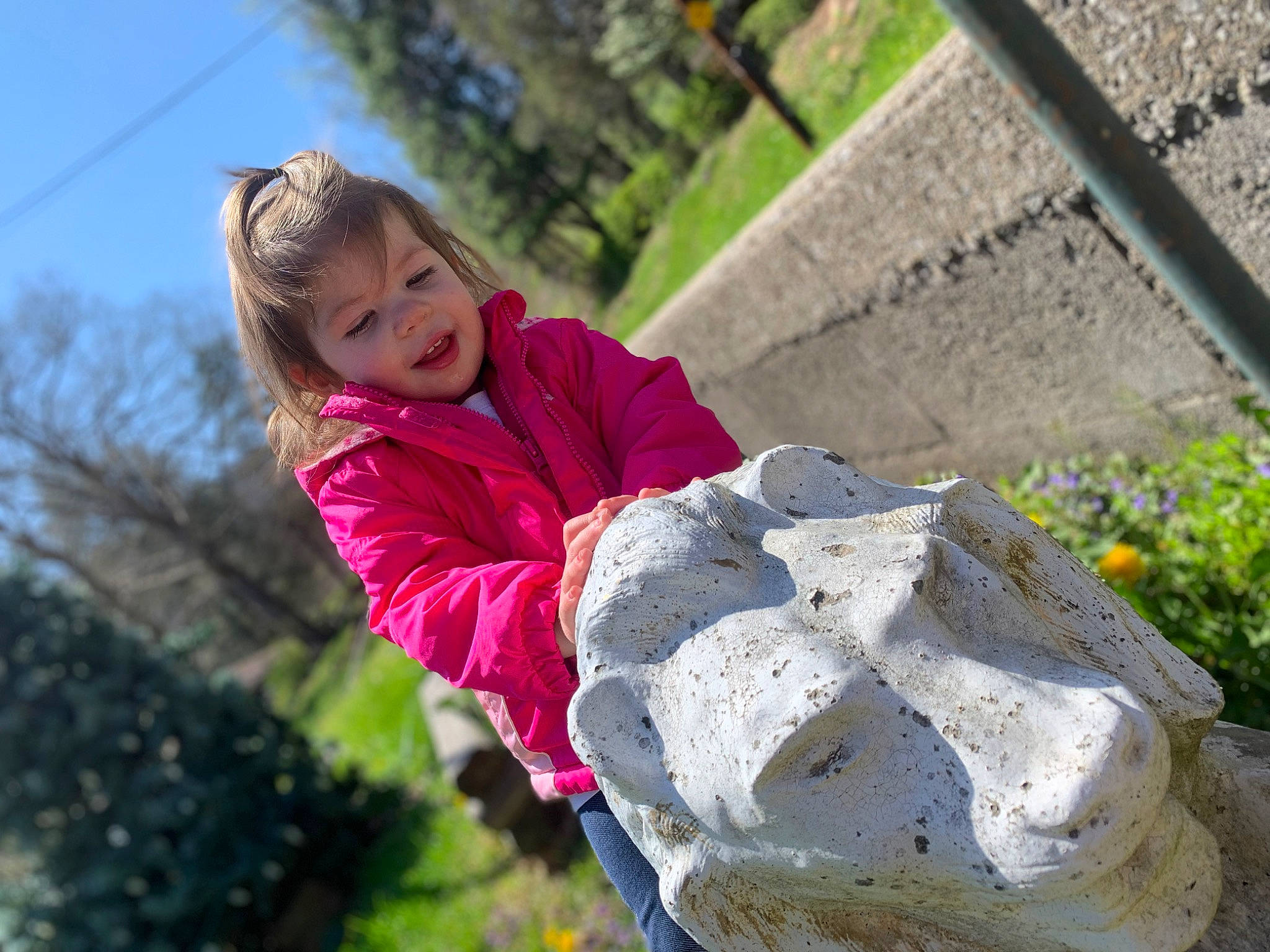 Natalie Grace is registered to the contest to win money with this photo: child, fun, garden, grass, happy, leisure, magenta, people_in_nature, person, plant, play, recreation, rock, rope, sitting, sky, soil, toddler, tree, vacation