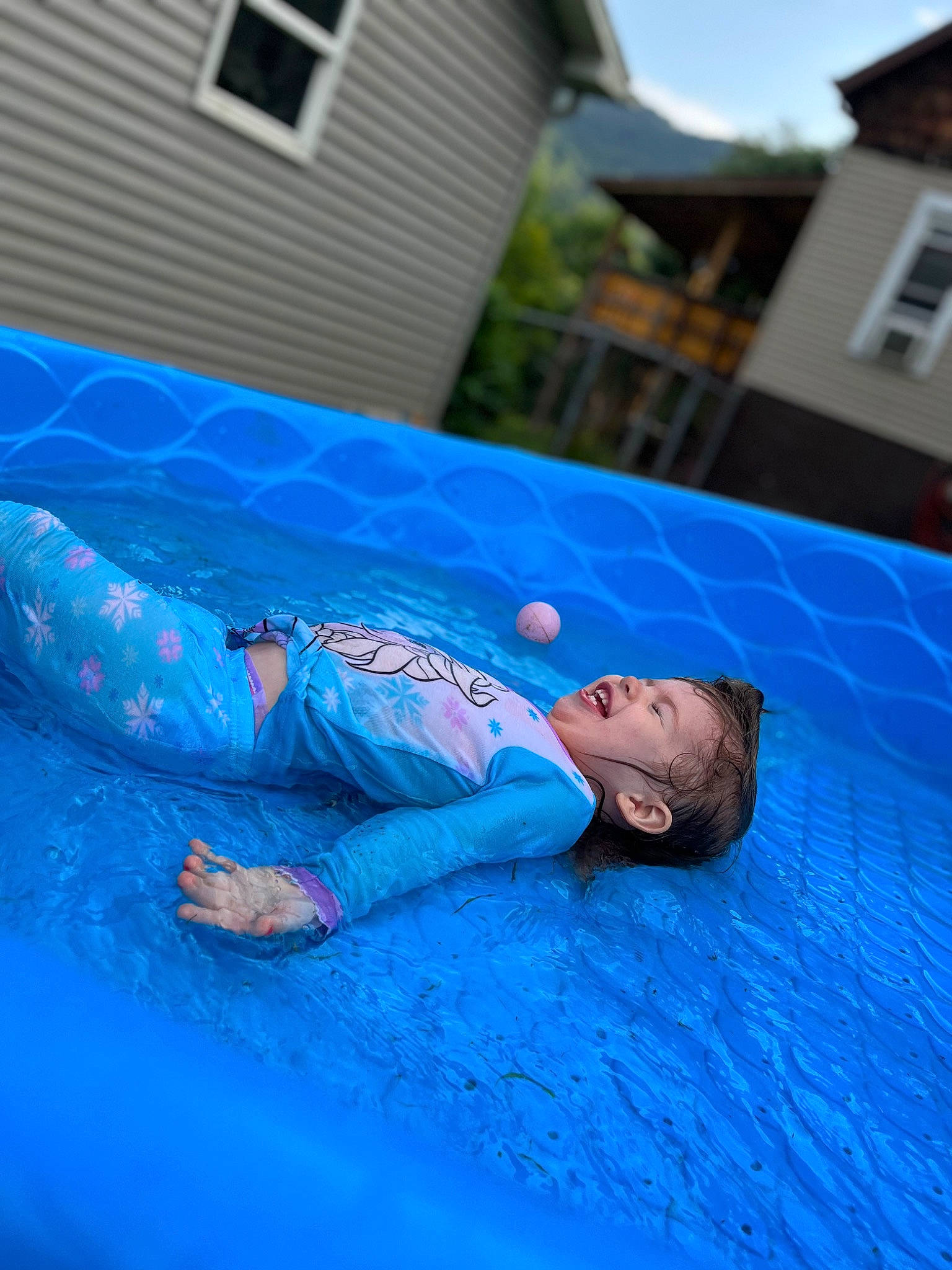 Natalie Grace is registered to the contest to win money with this photo: blue, child, competition_event, electric_blue, event, flooring, fun, games, grass, inflatable, leisure, outdoor_play_equipment, person, play, recreation, sitting, sports, tarpaulin, toddler, water