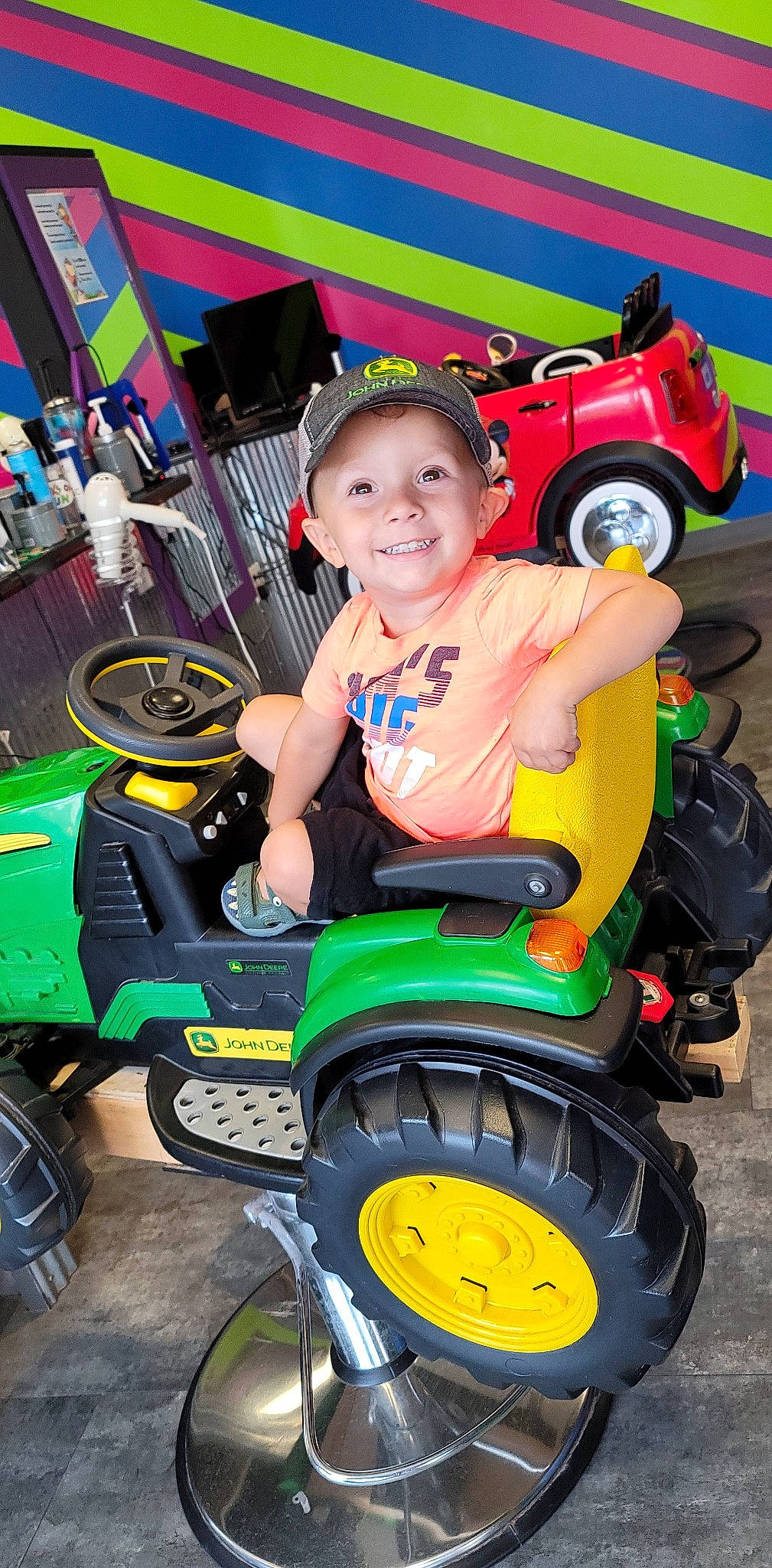 Kayson joined the competition — help win amazing prizes! automotive_design, automotive_tire, blue, eye, fender, green, head, headwear, joy, mode_of_transport, motor_vehicle, person, photograph, red, riding_toy, shorts, smile, tire, toddler, tread