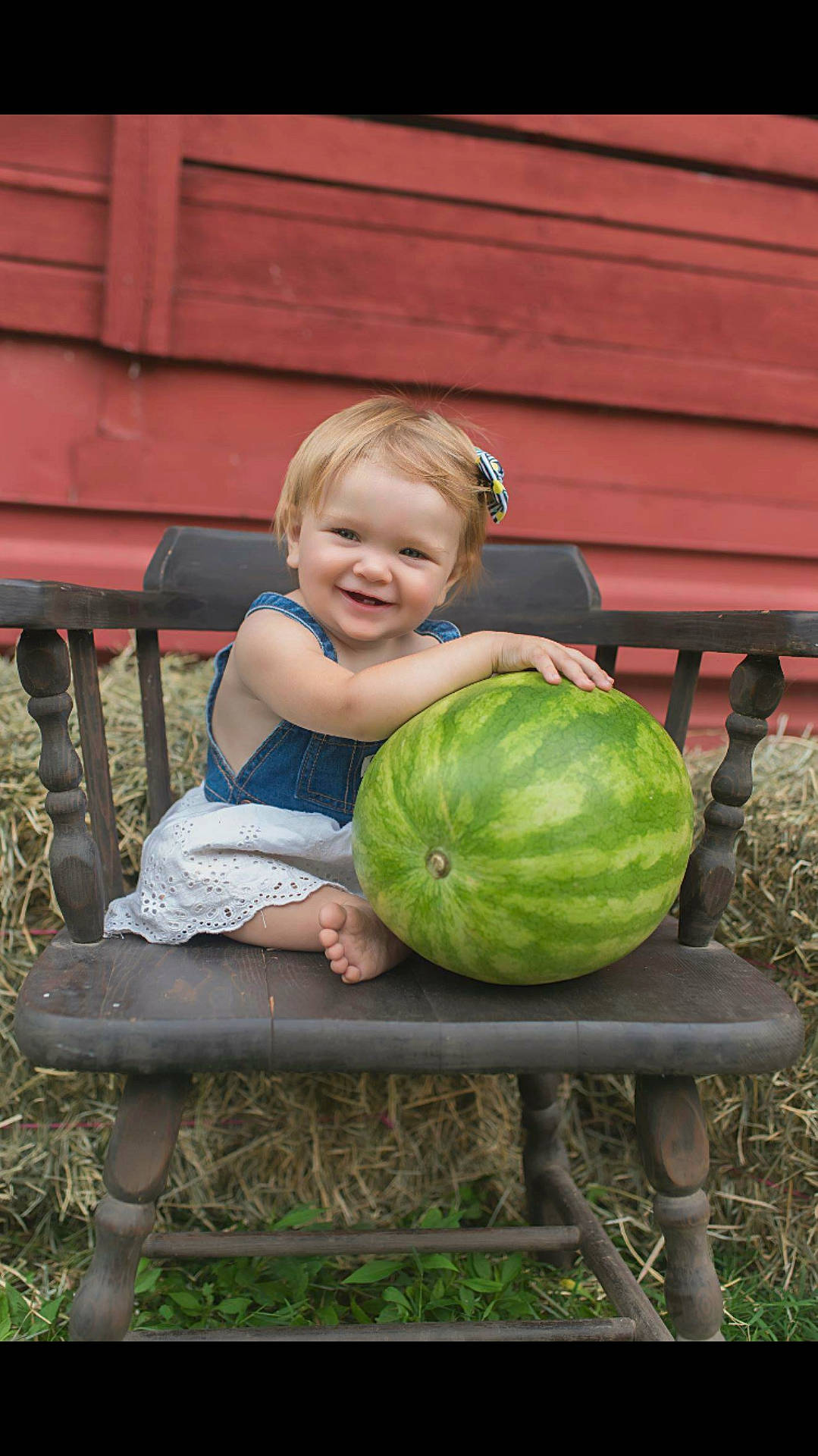 Emberly is registered to the contest to win money with this photo: child, citrullus, emotion, facial_expression, fun, girl, grass, green, joy, person, plant, play, sitting, smile, toddler, watermelon