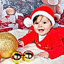 baby, blanket, celebration, child, christmas_ornaments, cute, festive, gift_wrap, gold_ball, happy, holiday, indoor, portrait, present, red_ball, red_clothing, santa_hat, smiling, teddy_bear, tutu
