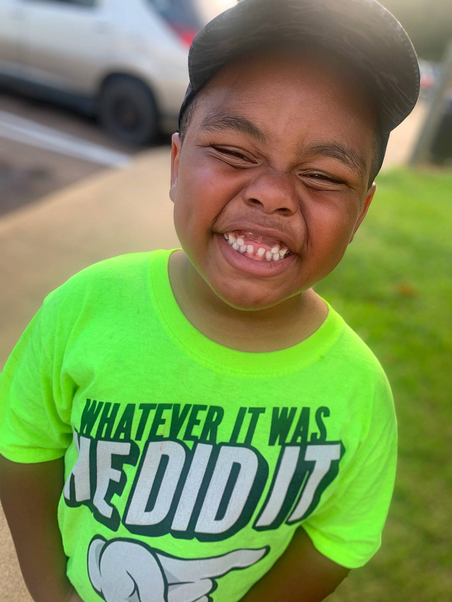 Makhi is registered to the contest to win money with this photo: active_shirt, asphalt, cap, child, cool, forehead, fun, gesture, grass, happy, leisure, mouth, neck, person, road, sleeve, smile, street_fashion, summer, t_shirt