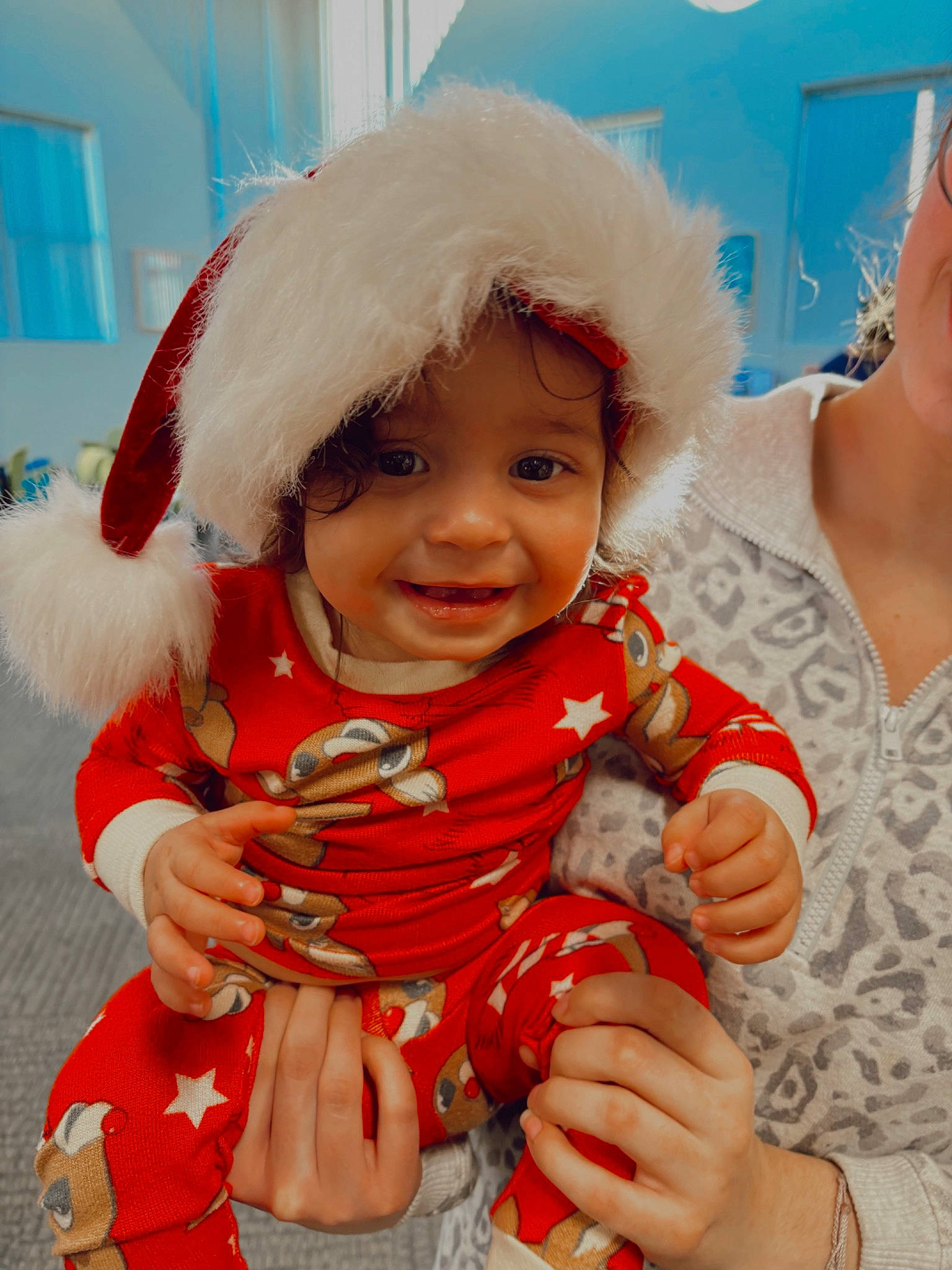 Alani joined the competition — help win amazing prizes! arm, baby, baby_toddler_clothing, cheek, child, event, eye, finger, fun, gesture, hand, happy, headwear, human_body, joy, lap, person, red, santa_claus, skin