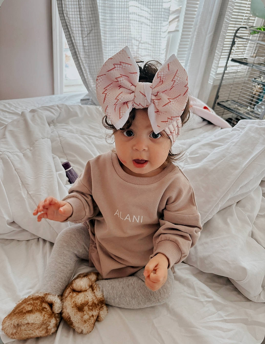 Alani joined the competition — help win amazing prizes! baby, baby_toddler_clothing, child, comfort, costume_hat, fashion_accessory, fur, hair_accessory, head, headband, headgear, headpiece, headwear, linens, pattern, peach, person, sitting, sleeve, textile