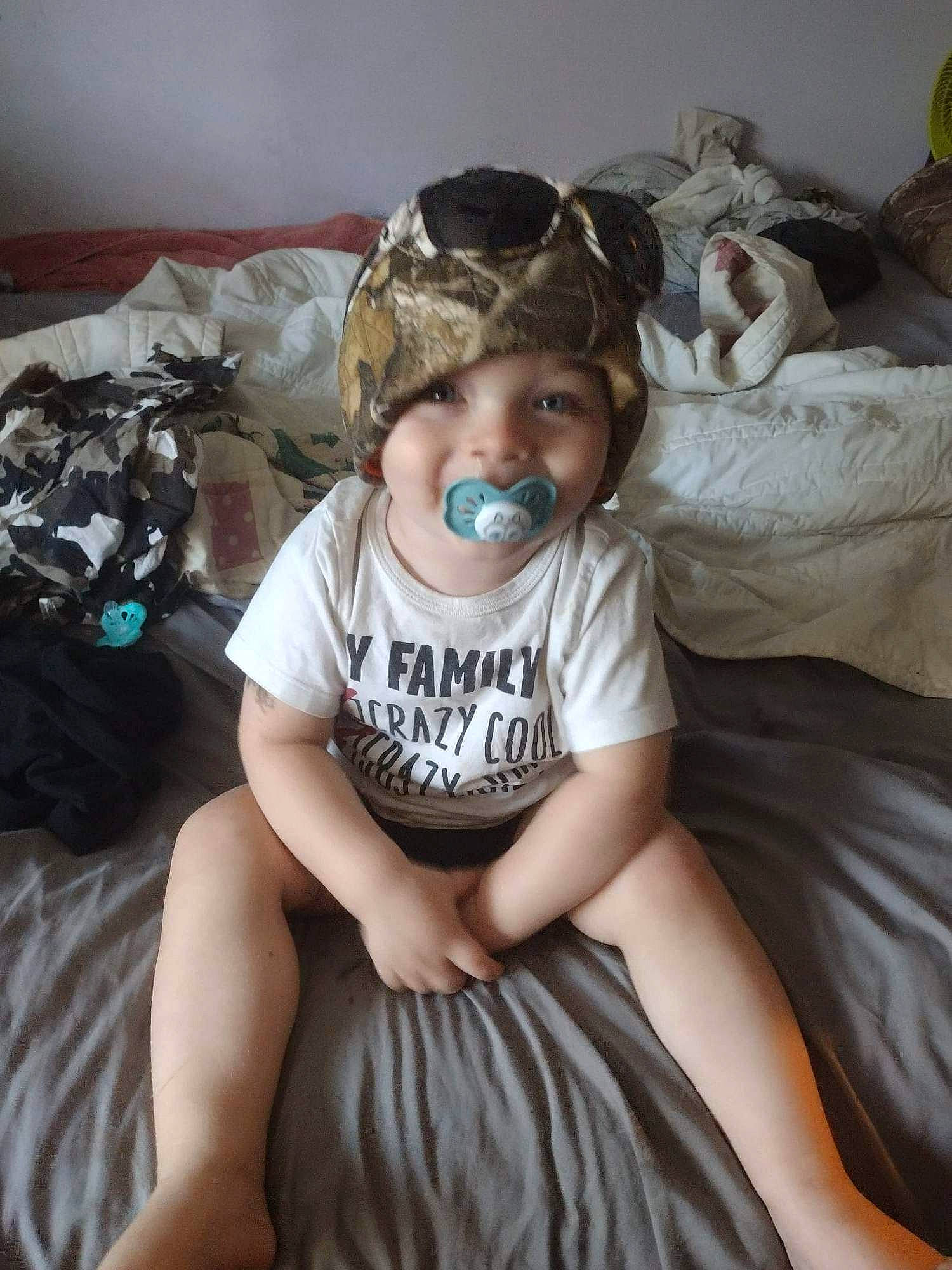 Joshua Hall Jr is registered to the contest to win money with this photo: baby, baby_toddler_clothing, beauty, bed, bedding, child, comfort, event, flash_photography, fun, happy, headwear, human_leg, linens, people, person, personal_protective_equipment, room, sitting, smile