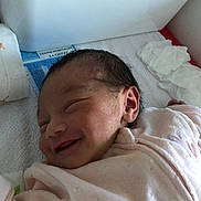 Heipoe Fontaine participe au concours pour gagner de l'argent avec cette photo : newborn, baby, smiling, blanket, hospital_bed, tissues, infant, sleeping, face, person, cute, cozy, soft, wrapped, indoors, healthcare, child, newborn_baby, pink, resting