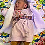 Heipoe Fontaine a rejoint le concours — aidez-le/la à gagner de superbes lots ! newborn, baby, sleeping, pink_dress, knitted_jacket, floral_blanket, patterned_belt, socks, toddler_clothing, cute, infant, portrait, resting, cozy, soft_texture, child, colorful, warm, peaceful, indoor