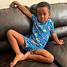 Eliab joined the competition — help win amazing prizes! child, boy, blue_outfit, mario_characters, couch, leather, relaxed_pose, barefoot, indoor, casual_clothing, person, short_hair, skin, furniture, seated, looking_at_camera, home, comfort, playful, portrait