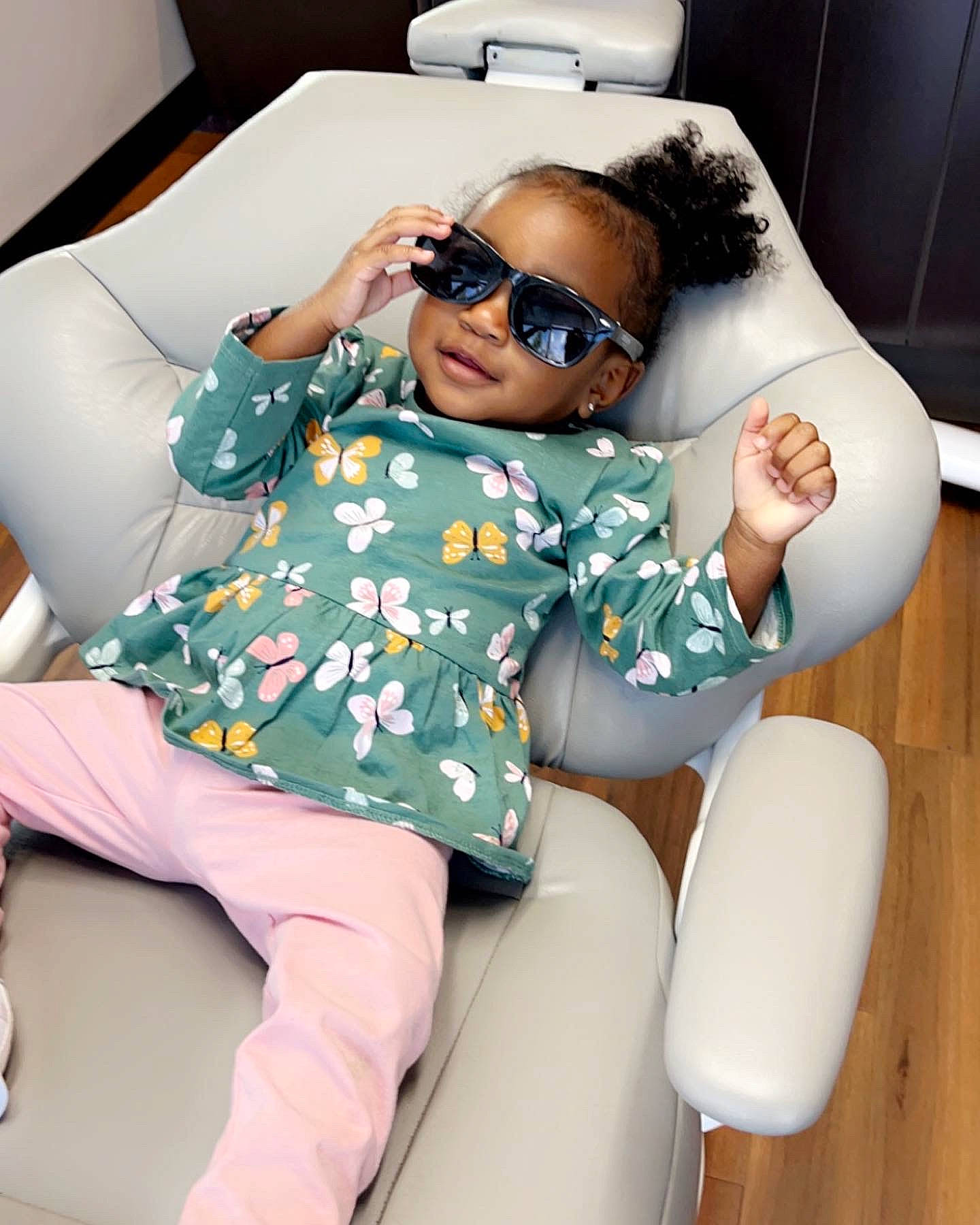 Brielle is registered to the contest to win money with this photo: automotive_design, black_hair, car_seat, child, comfort, eyewear, finger, fun, goggles, head, human_leg, joint, knee, lap, leisure, luxury_vehicle, person, sitting, sunglasses, thigh