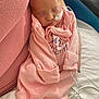 newborn, baby, infant, sleeping, pink_clothing, medical_tube, swaddled, resting, adult_arm, closeup, hospital, soft_lighting, peaceful, cute, child, person, bed, blanket, healthcare, tender