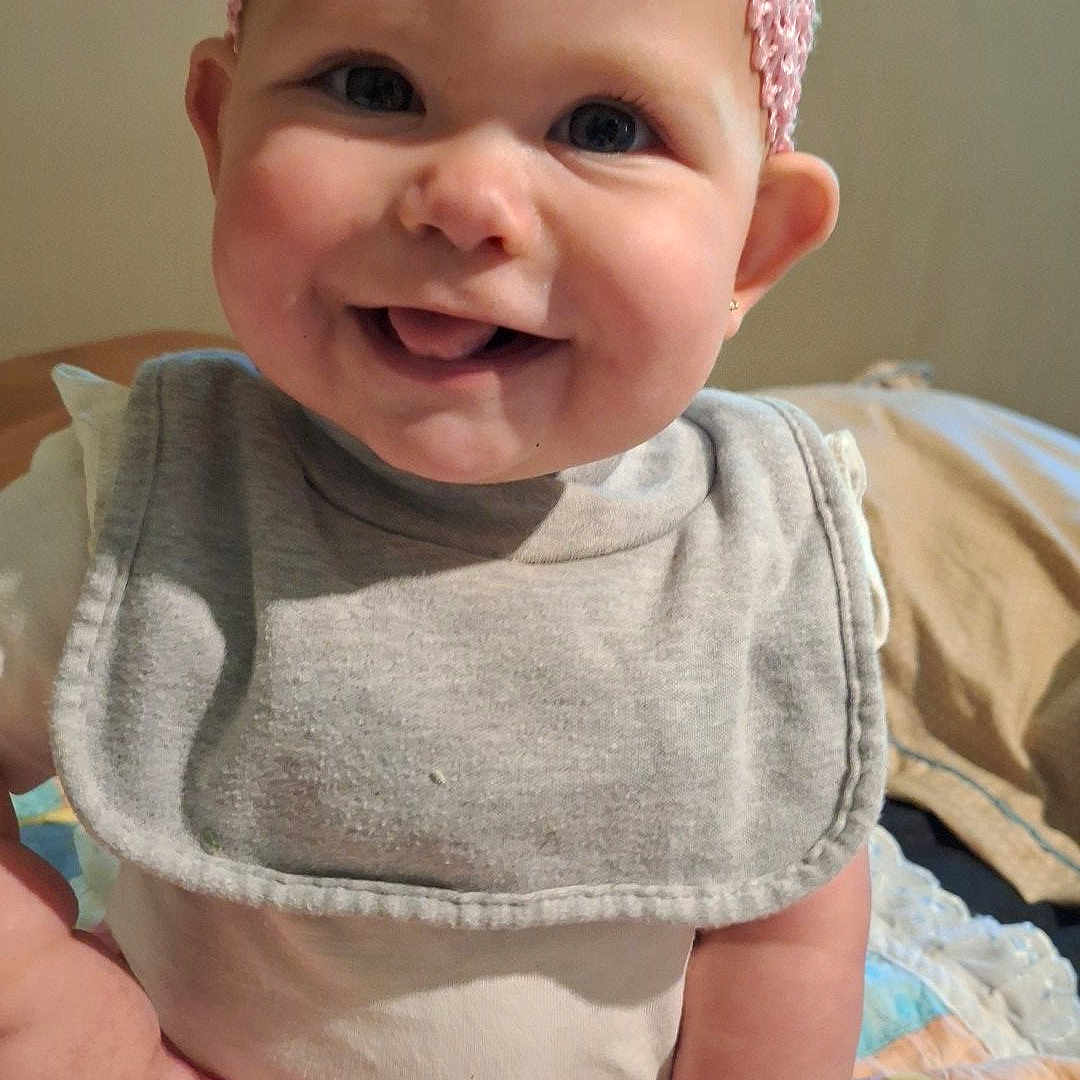 Emmy is registered to the contest to win money with this photo: accessories, baby, babylaughing, clothing, cushion, dress, face, happy, hat, head, headband, homedecor, jewelry, laughing, necklace, pants, person, photography, portrait, smile