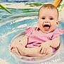 baby, infant, smiling, pink_dress, inflatable_ring, water, sitting, happy, child, cute, playful, summer, outdoor, toy, pool, feet, hands, face, joy, expression