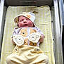 newborn, baby, sleeping, hospital, bassinet, yellow_blanket, winnie_the_pooh, hat, mittens, pants, socks, infant, cute, cozy, child, person, rest, soft, clothing, indoor