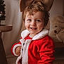 bow, burlap, child, cute, face, festive, furniture, happy, holiday, indoor, portrait, red_clothing, santa_suit, seasonal, smile, teddy_bear, toddler, toy, warm_lighting, young_child