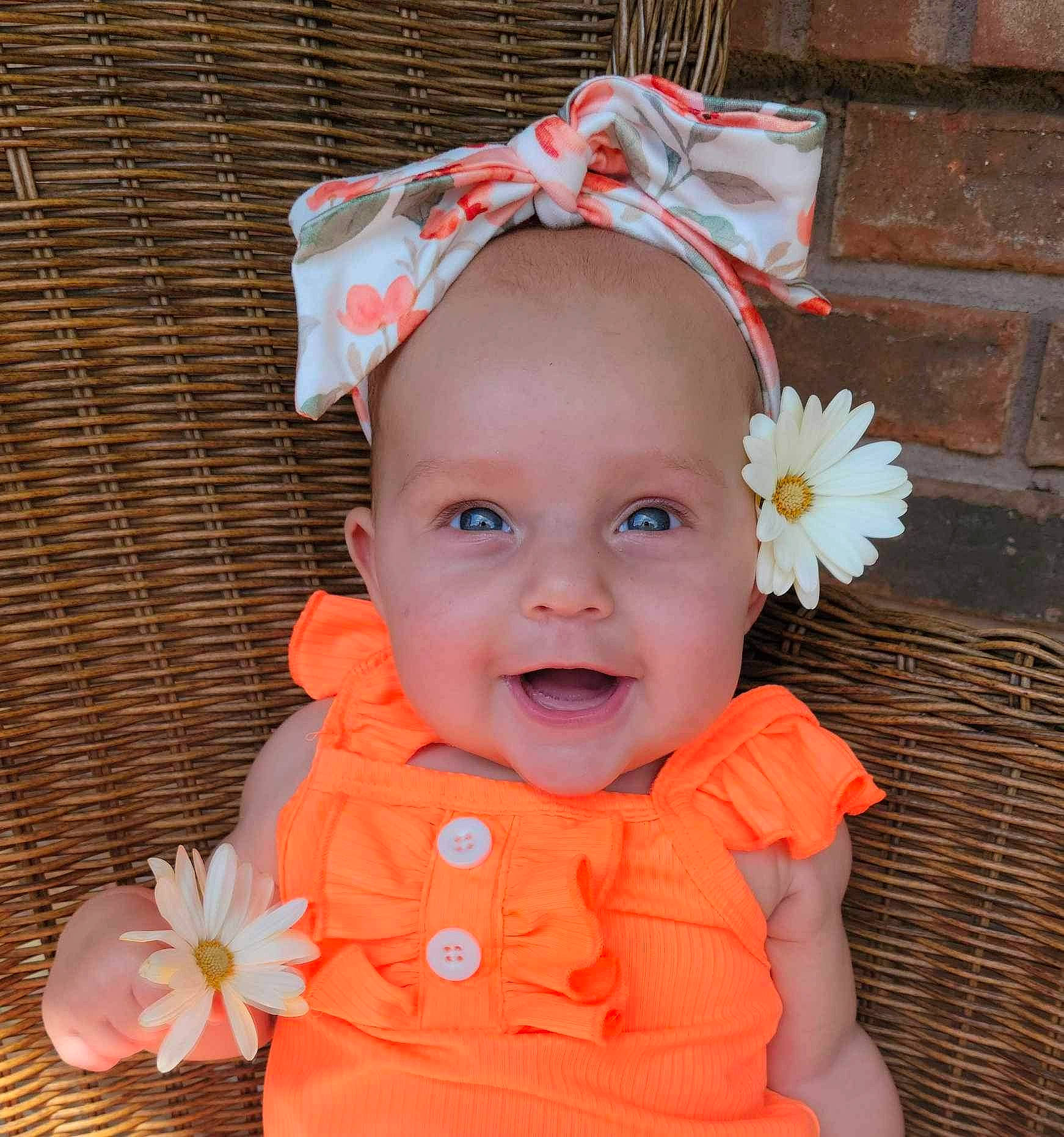Oaklyn Mae is registered to the contest to win money with this photo: baby, baby_toddler_clothing, cheek, child, costume_hat, eye, fashion_accessory, flower, happy, hat, headgear, headpiece, orange, peach, person, petal, pink, red, smile, textile
