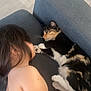 Nallely is registered to the contest to win money with this photo: child, cat, couch, calico_cat, sleeping, indoor, furniture, hair, skin, paw, pet, animal, resting, cozy, friendship, floor, wood_floor, relaxation, home, quiet