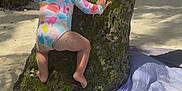 Olivia joined the competition — help win amazing prizes! barefoot, beach, blanket, casual_clothing, child, climbing, daylight, exploration, moss, nature, outdoor, play, sand, summer, sunlight, swimsuit, toddler, tree, vacation, young_child