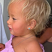 Olivia joined the competition — help win amazing prizes! baby, blonde_hair, casual, child, closeup, clothing, curly_hair, cute, earring, fashion, human, indoors, necklace, person, portrait, purple_top, side_profile, skin, toddler, young_child
