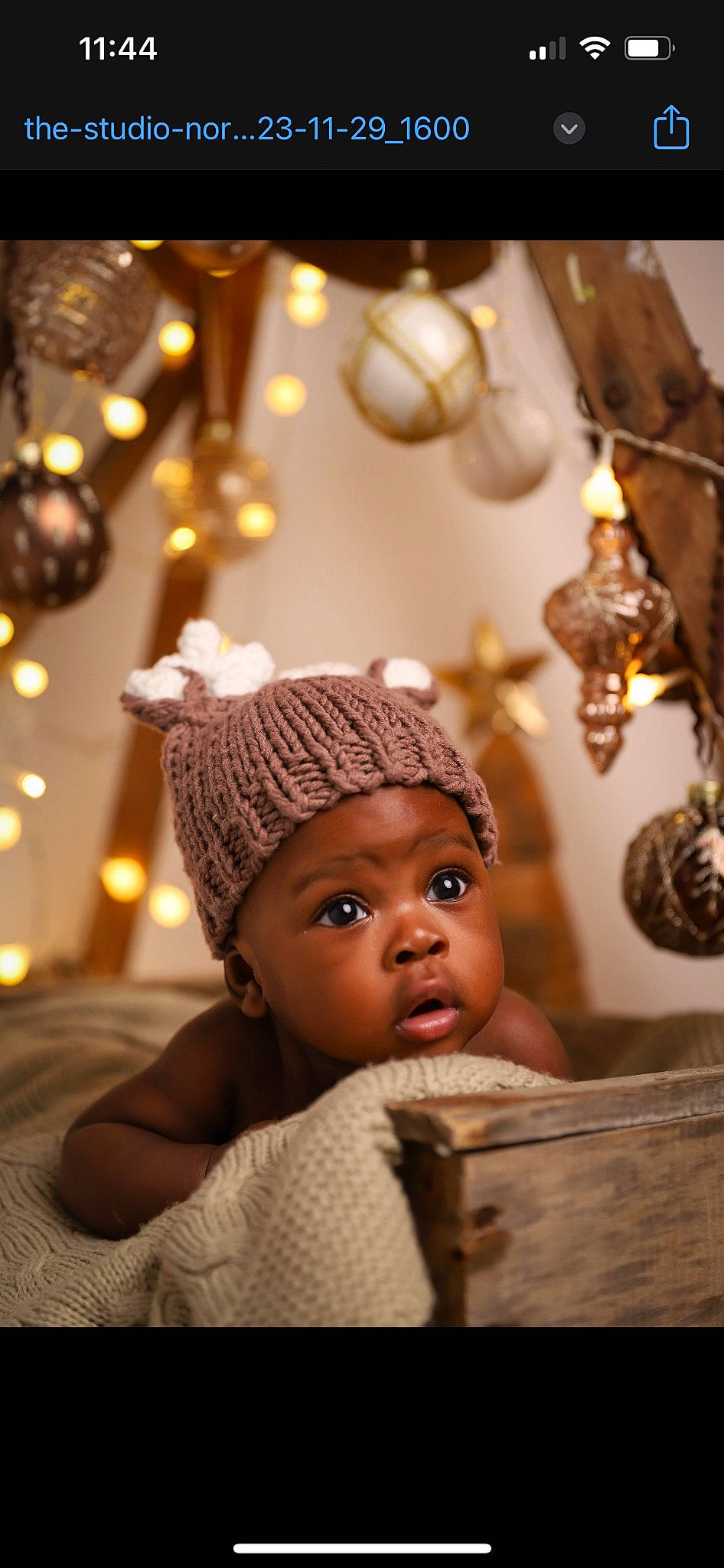 Jameel joined the competition — help win amazing prizes! baby, child, christmas_ornament, event, eye, fashion_accessory, flash_photography, flooring, fun, happy, headgear, holiday, knit_cap, ornament, person, room, sitting, surprise, toddler, tradition