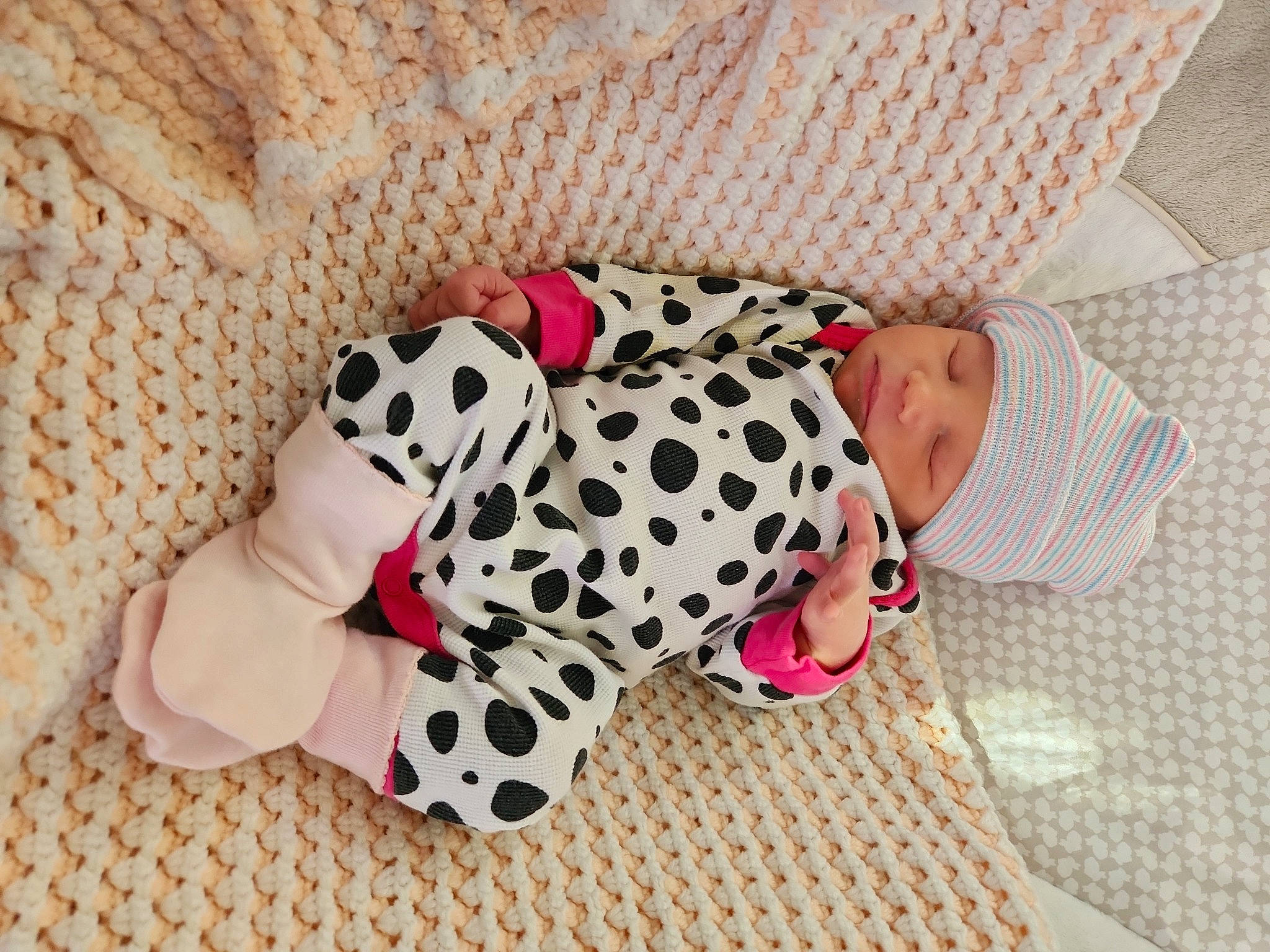 Skyler is registered to the contest to win money with this photo: baby, baby_products, baby_toddler_clothing, baby_toys, bed_sheet, bedding, carmine, child, comfort, couch, doll, fawn, flooring, headwear, linens, pattern, person, pink, plush, sleeve