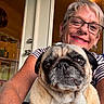 animal, close_up, companion, dog, door, earrings, face, furniture, glasses, happy, home, indoor, light, pet, portrait, pug, selfie, smiling, striped_shirt, woman