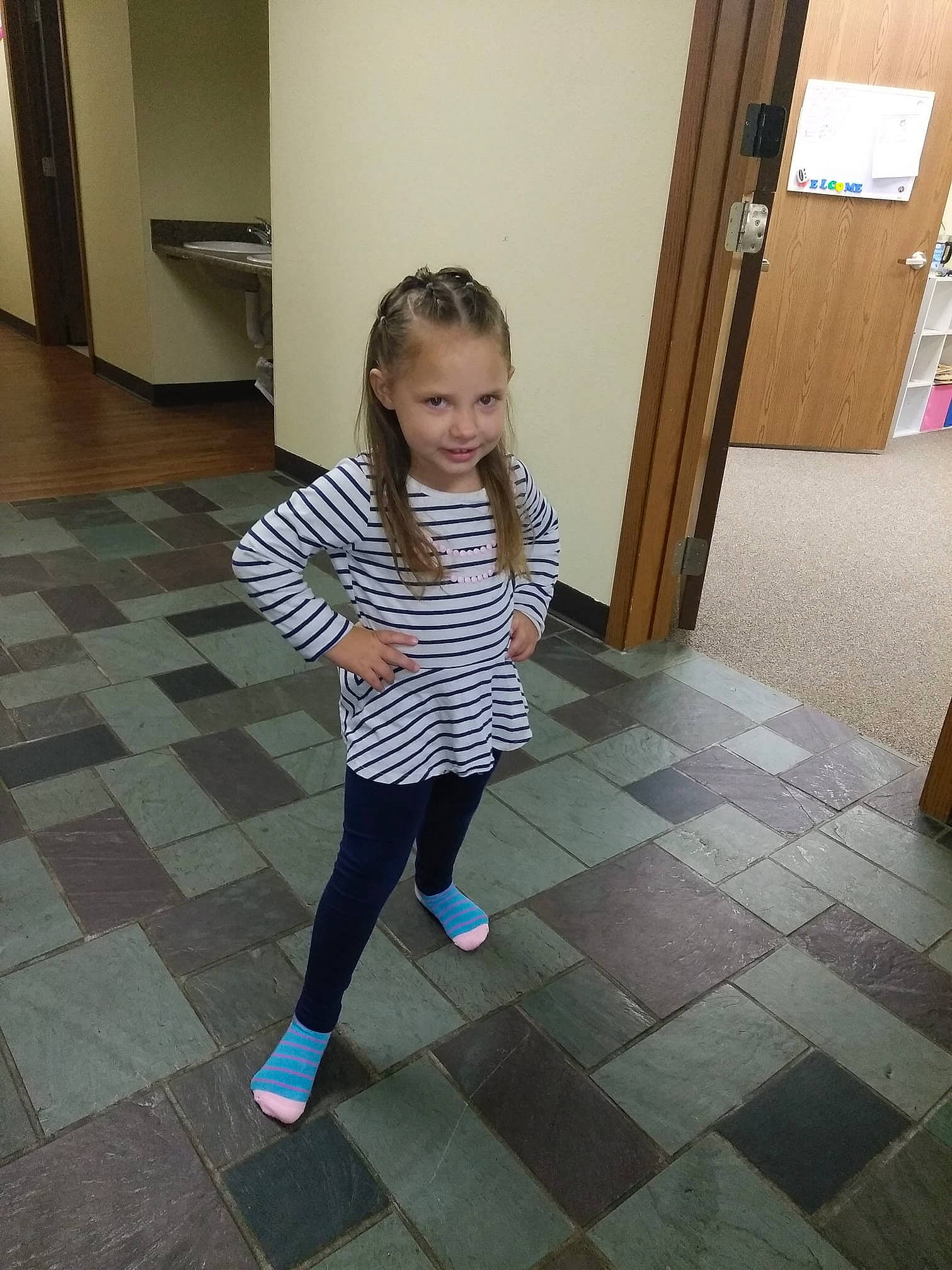 Dakota is registered to the contest to win money with this photo: child, clothing, day, design, floor, flooring, footwear, fun, girl, human_body, joint, leg, pattern, person, product, shoe, shoulder, snapshot, standing, textile