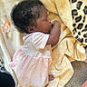 baby, sleeping, blanket, pacifier, pink_dress, curly_hair, infant, soft_texture, carpet, leopard_print, cuteness, nursery, cozy, foot, child, resting, indoors, toddler, peaceful, clothing