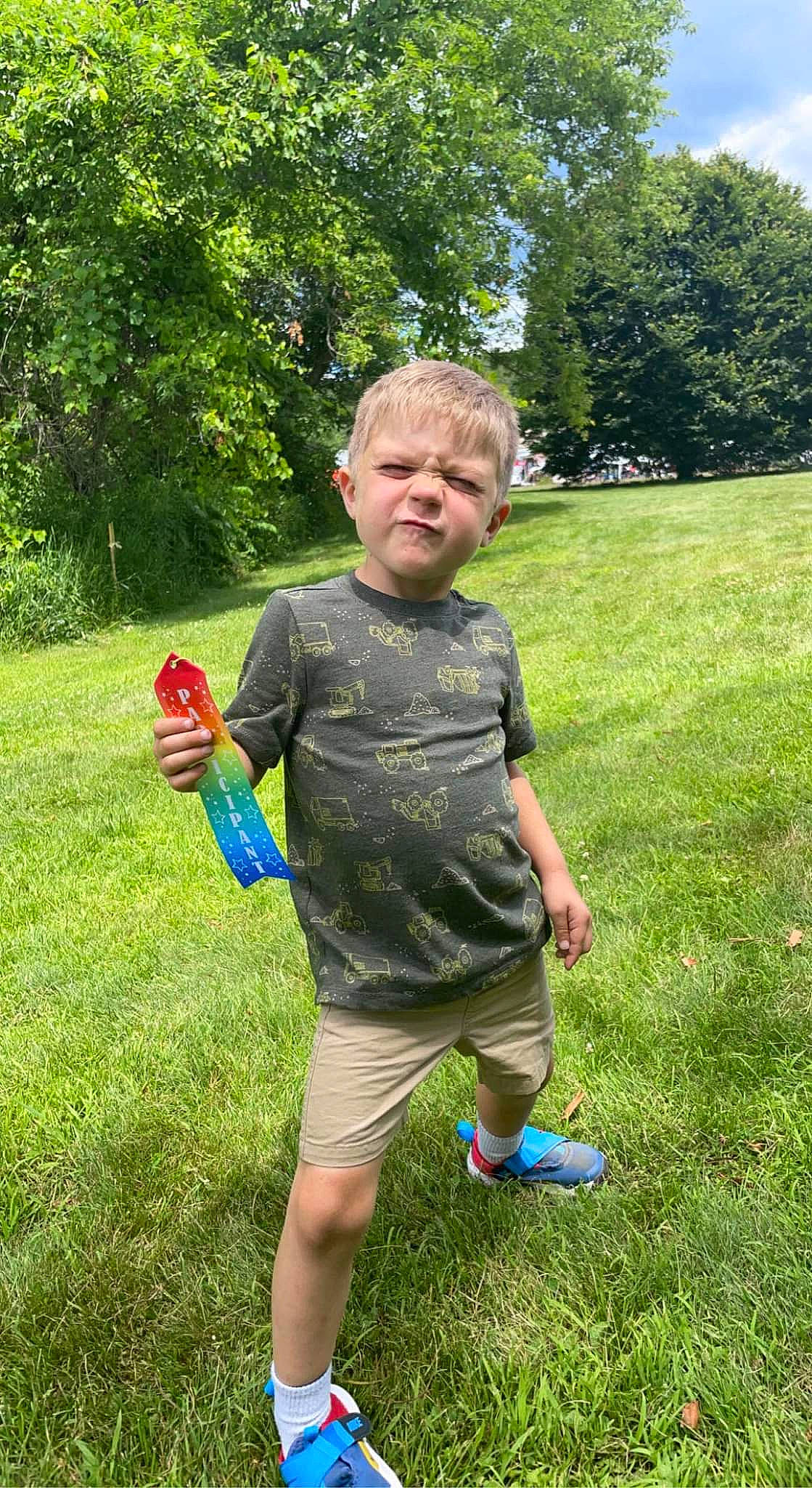 Julian is registered to the contest to win money with this photo: anger, ball, child, fun, garden, gesture, grass, grassland, happy, lawn, leisure, people_in_nature, person, plant, recreation, shorts, shrub, soil, sorrow, t_shirt