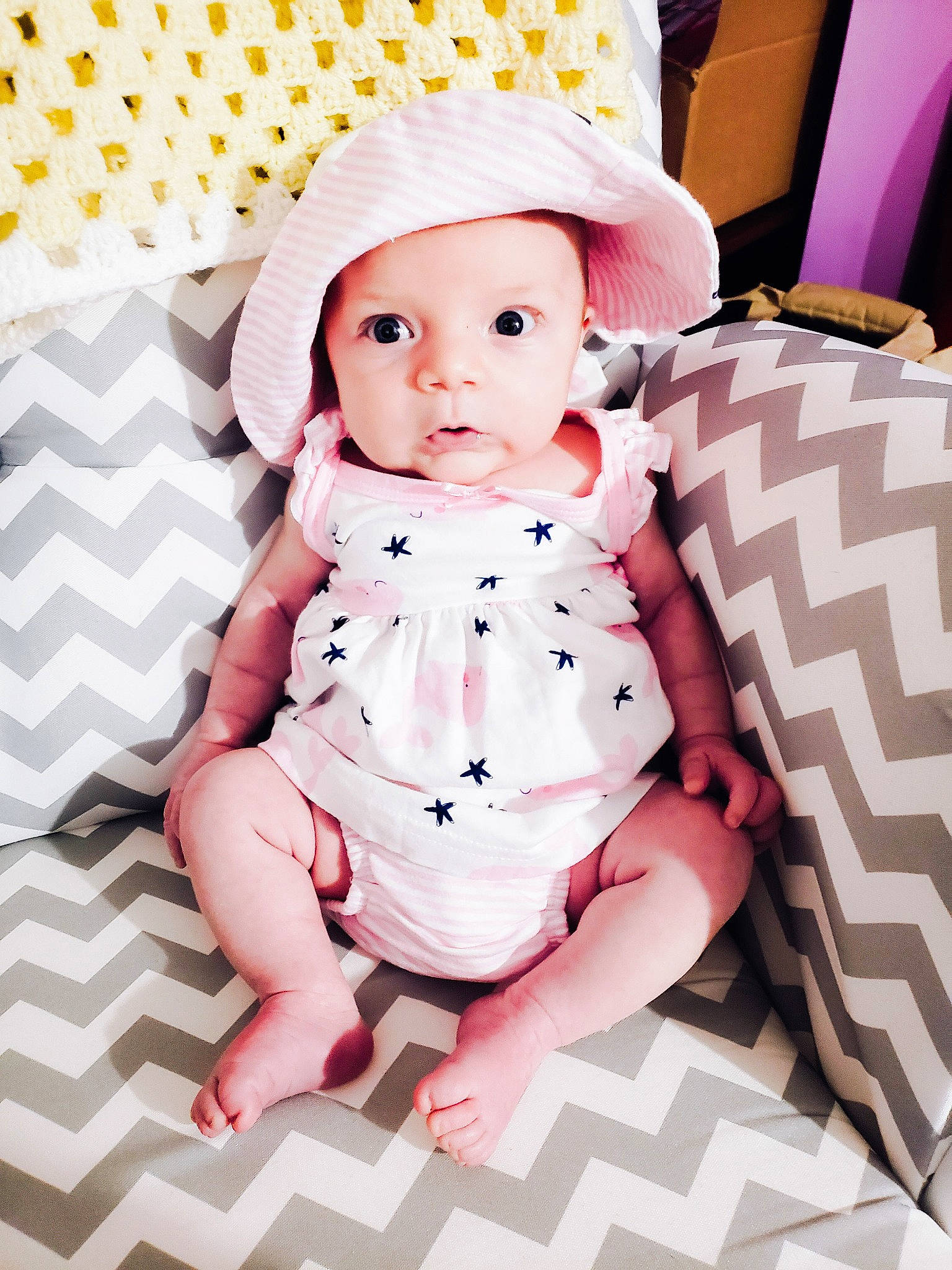 Adelaide is registered to the contest to win money with this photo: baby, baby_products, baby_toddler_clothing, cheek, child, doll, eyelash, fashion_accessory, headwear, human_leg, linens, one_piece_garment, pattern, peach, person, pink, sitting, skin, sleeve, thigh