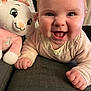 Alba a rejoint le concours — aidez-le/la à gagner de superbes lots ! baby, smiling, crawling, plush_toy, couch, indoor, person, face, child, cute, happy, furniture, soft_toy, pink, clothing, hand, eyes, nose, mouth, background