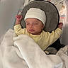 August is registered to the contest to win money with this photo: baby, babycare, blanket, child, comfort, crib, hat, headwear, indoors, infant, mesh, pajamas, peaceful, relaxing, resting, sleeping, soft, toddler, white, yellow